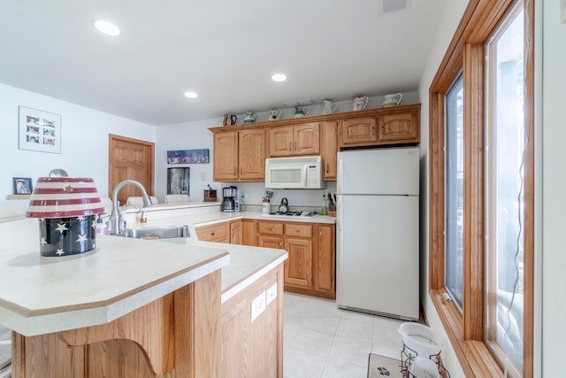 kitchen featuring sink, kitchen peninsula, white appliances, and light tile patterned floors