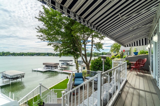 balcony featuring a water view and a boat dock