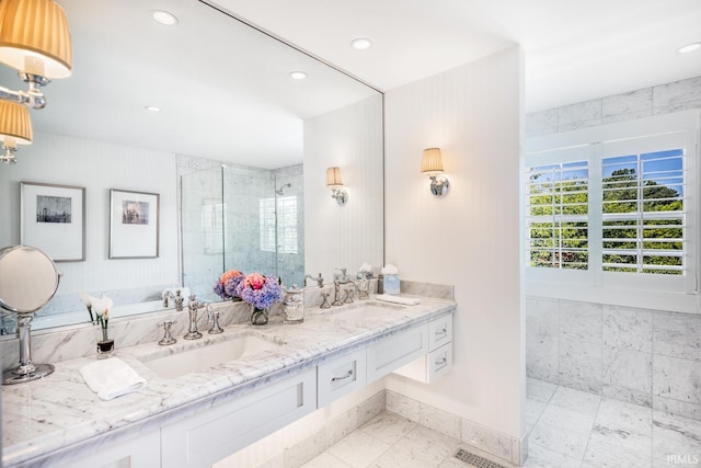 bathroom with double vanity, a stall shower, a sink, and recessed lighting