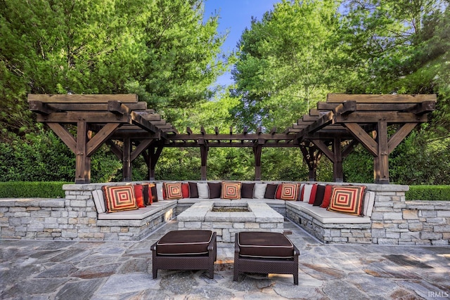 view of patio featuring an outdoor living space with a fire pit