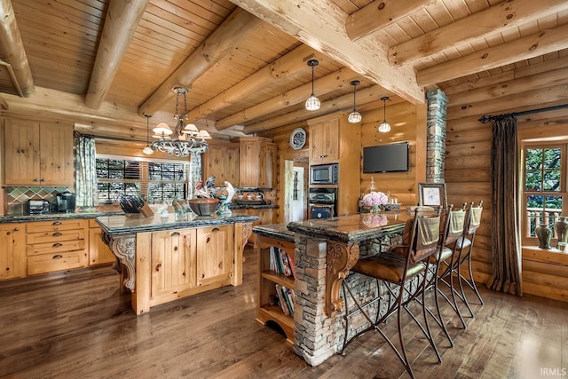 kitchen with dark wood-style floors, a center island, decorative light fixtures, light brown cabinetry, and appliances with stainless steel finishes