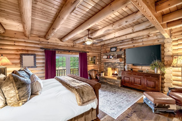 bedroom featuring wood ceiling, wood finished floors, and a stone fireplace