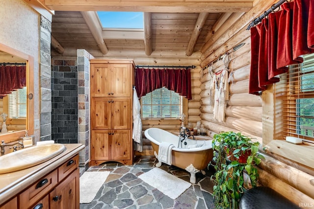 full bathroom featuring wood ceiling, a freestanding tub, beam ceiling, and stone floors