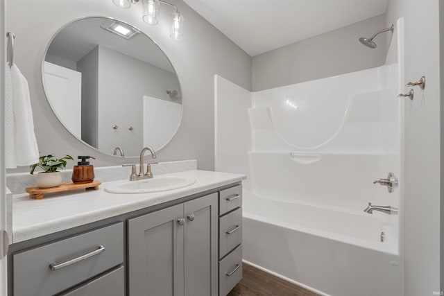 full bathroom with bathing tub / shower combination, wood finished floors, and vanity