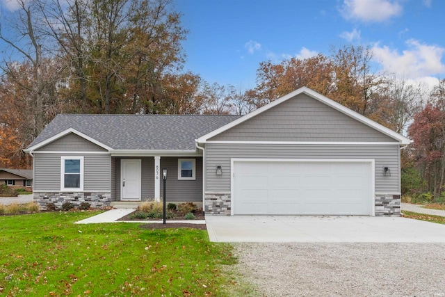 view of front of home featuring an attached garage, stone siding, a front lawn, and concrete driveway