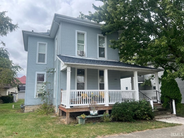 view of front of property with a porch, a front lawn, and cooling unit