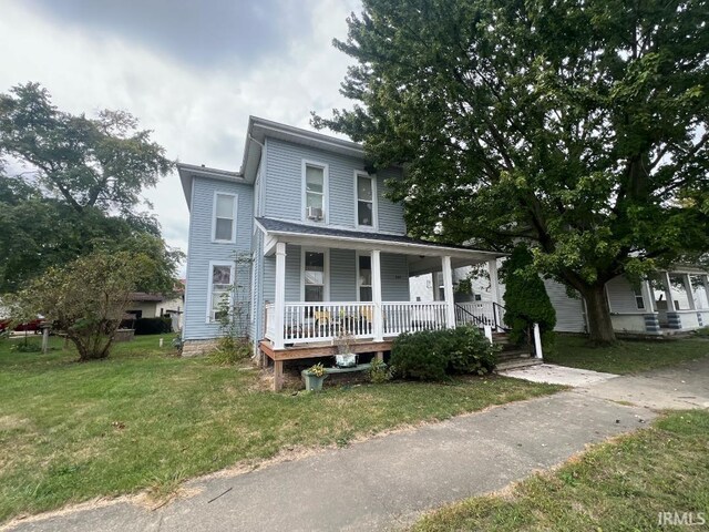 view of front of property with a porch and a front yard