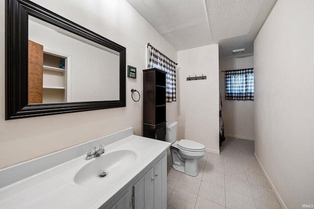 bathroom with vanity, tile patterned flooring, and toilet