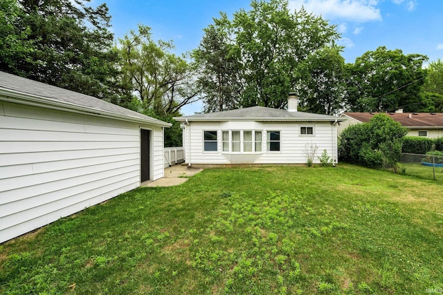 rear view of house featuring a lawn