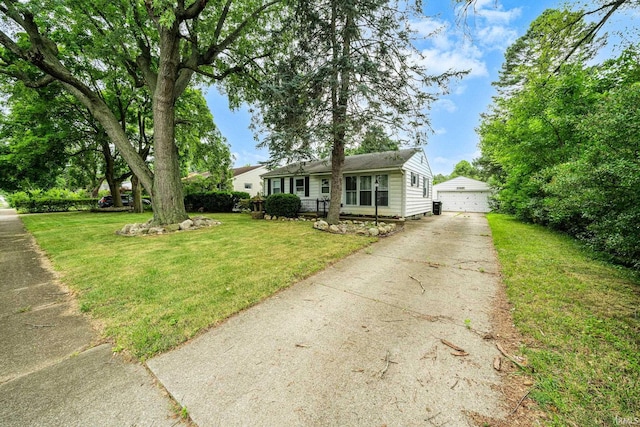 view of front of property featuring an outdoor structure, a garage, and a front lawn