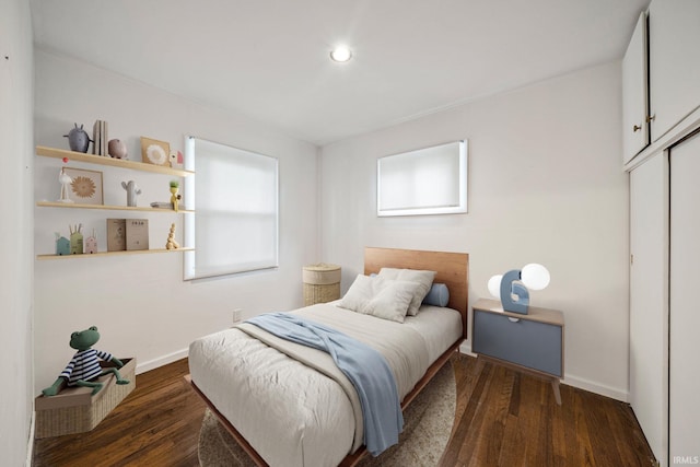 bedroom featuring dark hardwood / wood-style flooring and a closet