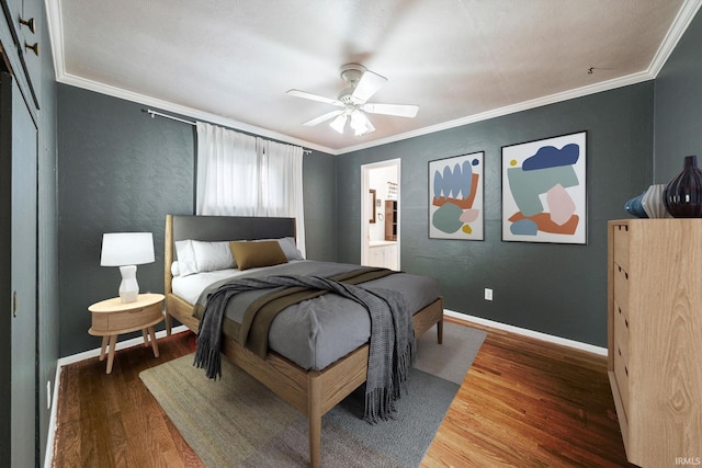 bedroom with dark hardwood / wood-style floors, ceiling fan, and ornamental molding