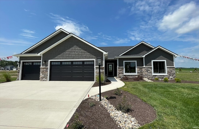 craftsman inspired home featuring a front lawn and a garage