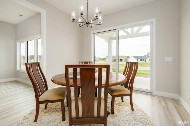 dining area featuring light hardwood / wood-style floors and a chandelier