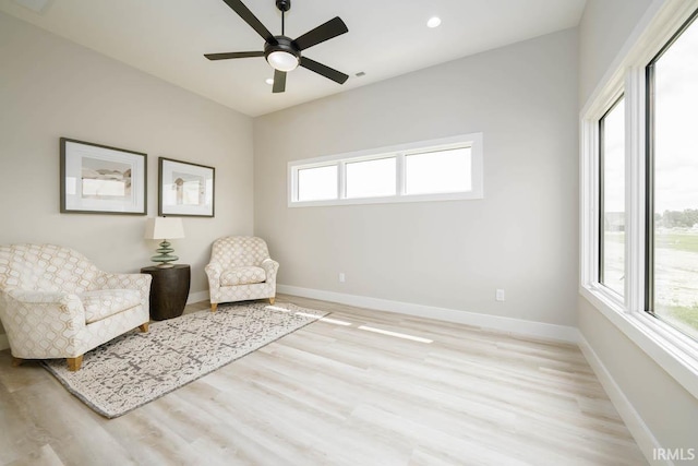 unfurnished room with ceiling fan, light hardwood / wood-style flooring, and a healthy amount of sunlight