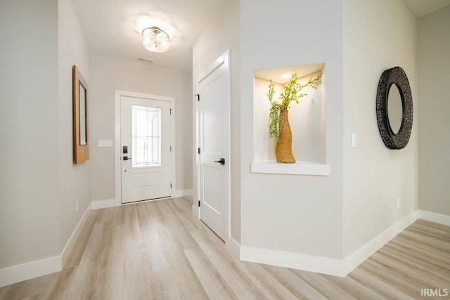 doorway with light wood-type flooring