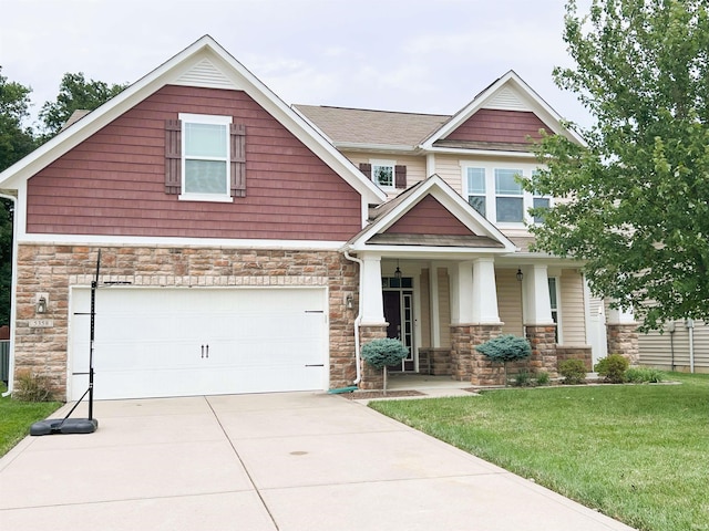 craftsman inspired home with a garage and a front lawn