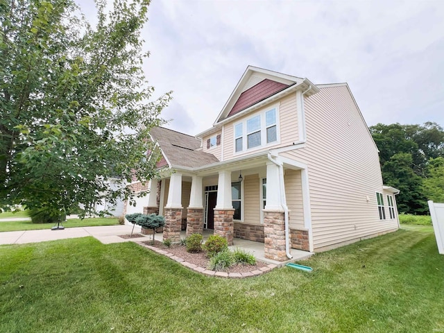 view of front of property with covered porch and a front lawn