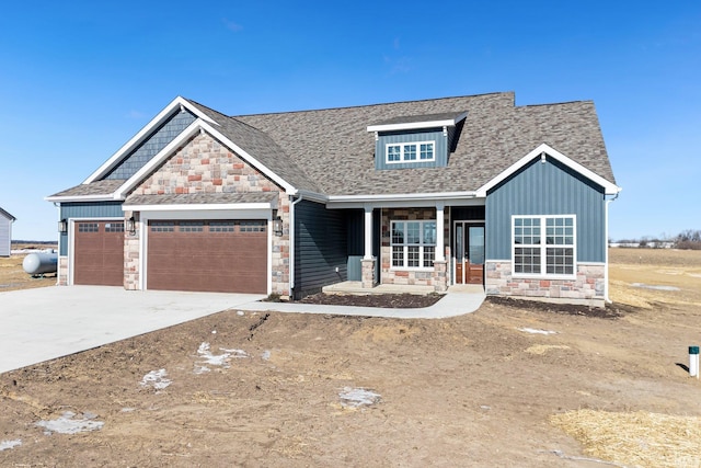 6711 W Division Line Rd, Delphi, IN 46923 - craftsman-style house with a garage, stone siding, board and batten siding, concrete driveway, and a porch