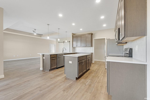6711 W Division Line Rd, Delphi, IN 46923 - kitchen featuring a kitchen island, baseboards, appliances with stainless steel finishes, and decorative backsplash
