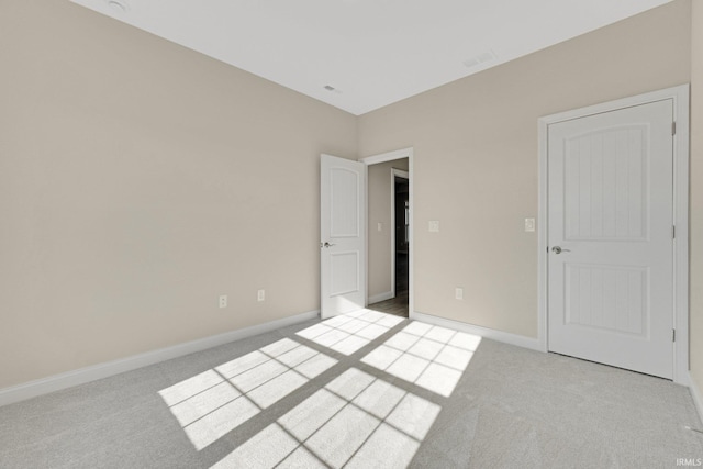 unfurnished bedroom featuring light colored carpet