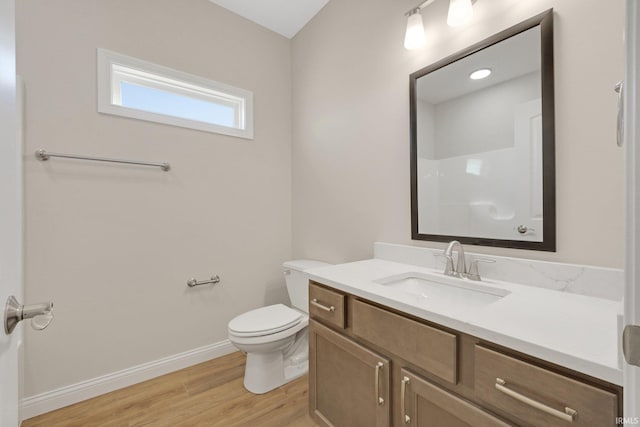 bathroom featuring vanity, hardwood / wood-style floors, and toilet