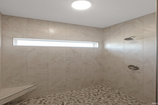 bathroom with tiled shower