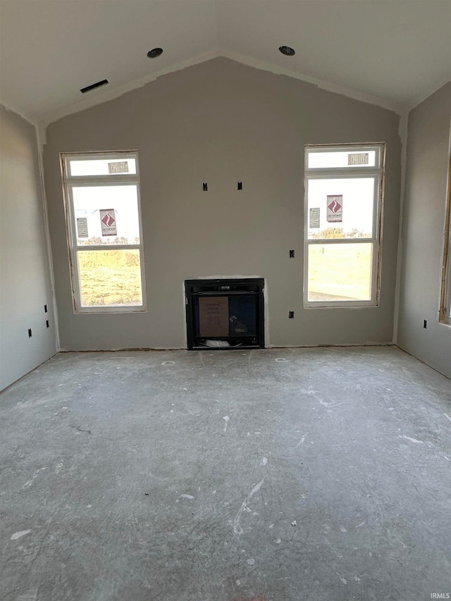 unfurnished living room featuring vaulted ceiling