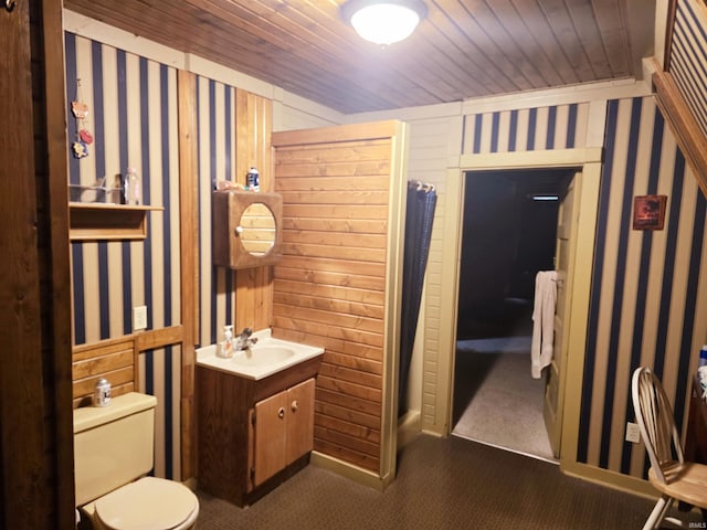 bathroom with vanity, toilet, and wooden ceiling