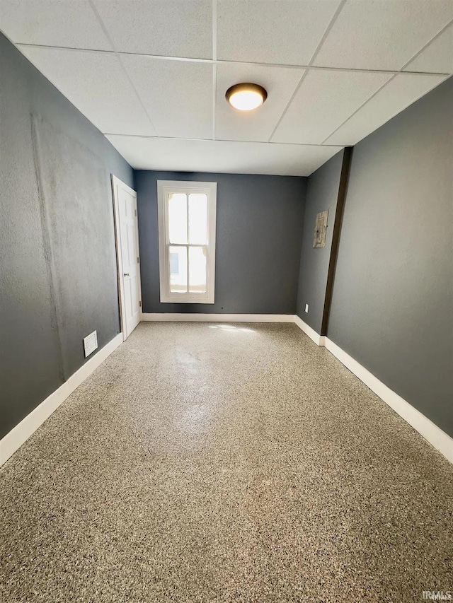 spare room featuring a paneled ceiling