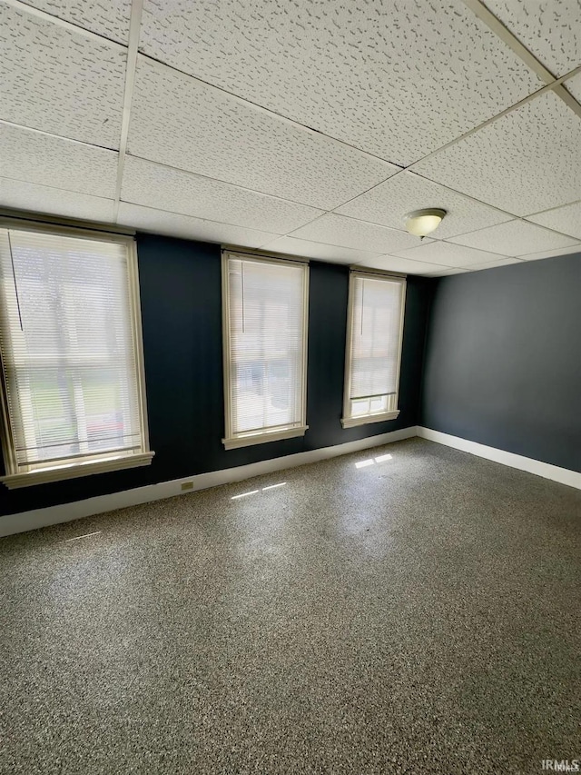 unfurnished room with a drop ceiling