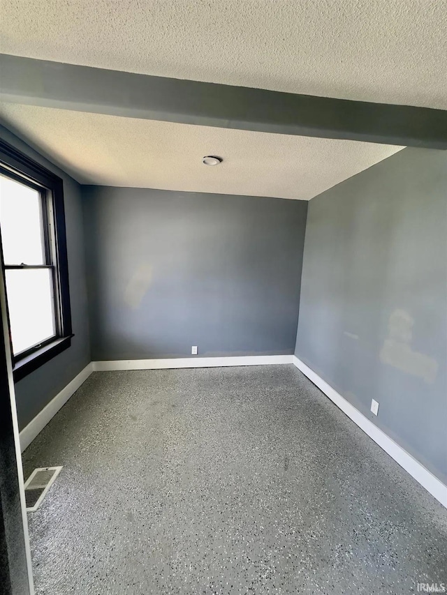 empty room with a textured ceiling