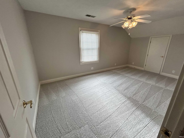 interior space featuring lofted ceiling, light carpet, and ceiling fan