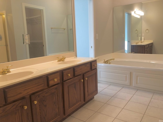 bathroom with vanity, tile patterned floors, and a tub