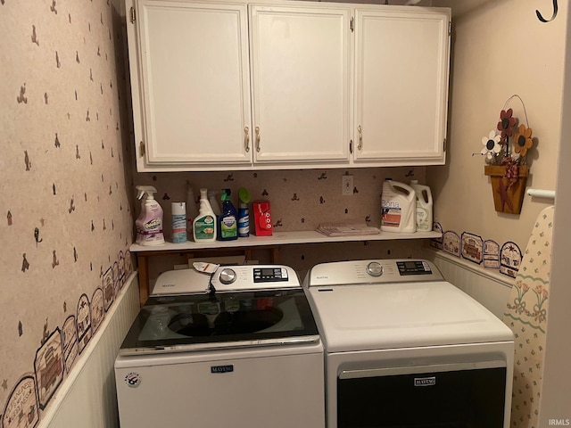 washroom featuring cabinets and independent washer and dryer