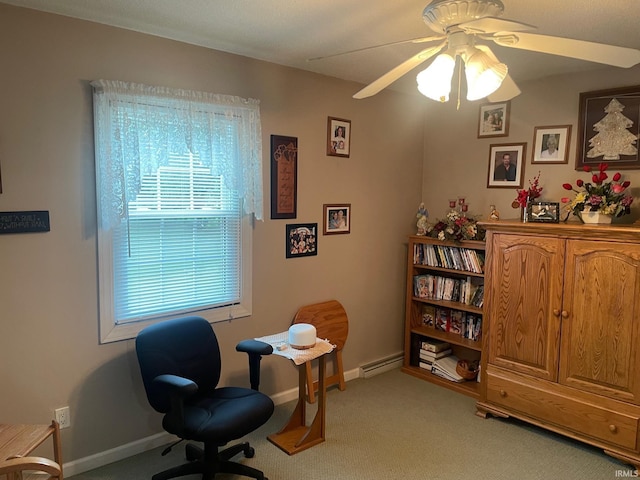 carpeted office featuring ceiling fan and a baseboard heating unit