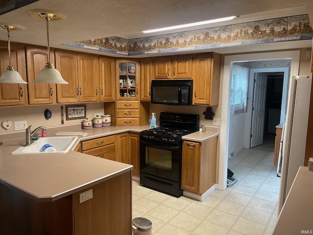 kitchen featuring sink, kitchen peninsula, a textured ceiling, decorative light fixtures, and black appliances