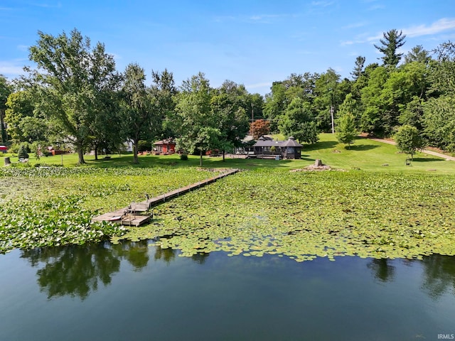 exterior space featuring a water view and a yard