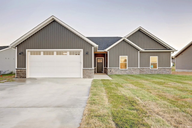 view of front of home with a front lawn and a garage