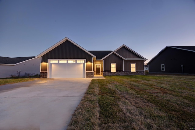 modern inspired farmhouse featuring a lawn, central AC, and a garage