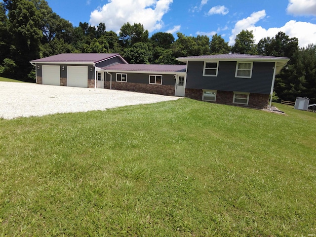 tri-level home featuring a garage and a front lawn