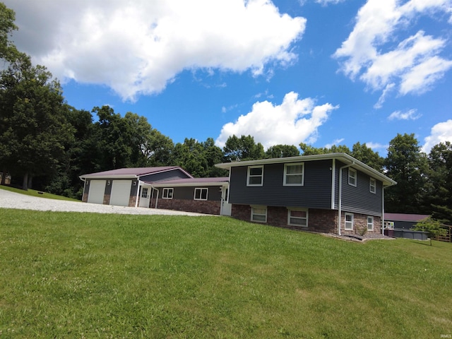 split level home featuring a garage and a front yard