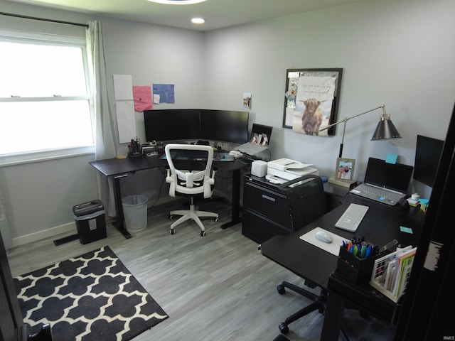 office area with light hardwood / wood-style floors