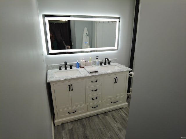 bathroom featuring vanity and hardwood / wood-style floors