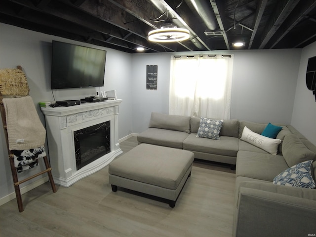 living room with a fireplace and light hardwood / wood-style floors