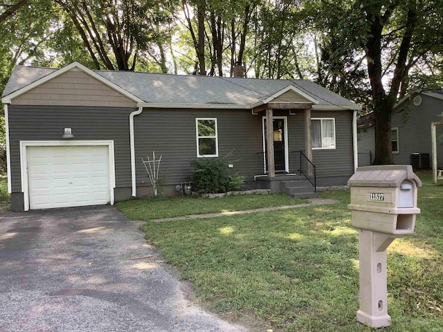 view of front of property with a garage and a front lawn