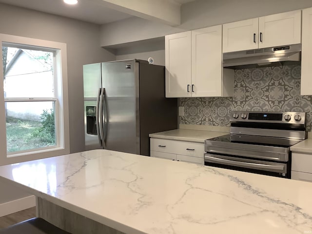 kitchen with stainless steel appliances, tasteful backsplash, light stone counters, dark hardwood / wood-style flooring, and white cabinets