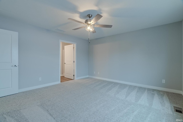 carpeted spare room featuring ceiling fan