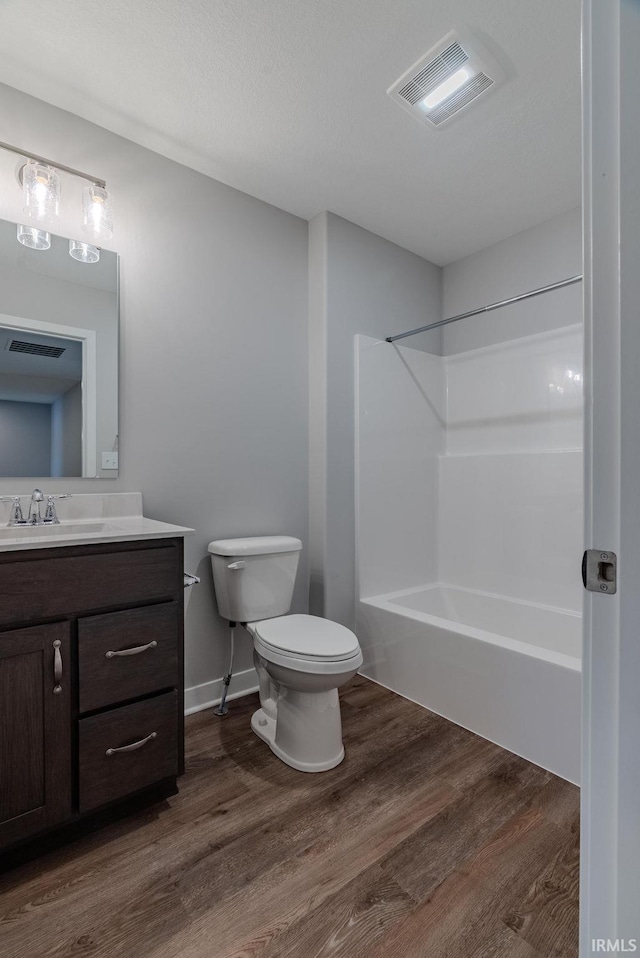 full bathroom featuring shower / bathing tub combination, vanity, wood-type flooring, and toilet