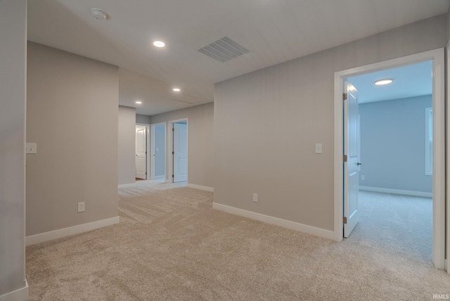 unfurnished room featuring light carpet